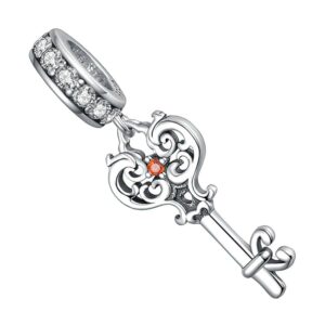 pendentif charm clé ancienne en argent et zircon rouge