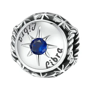 Charm Balance en argent avec zircon bleu profond.
